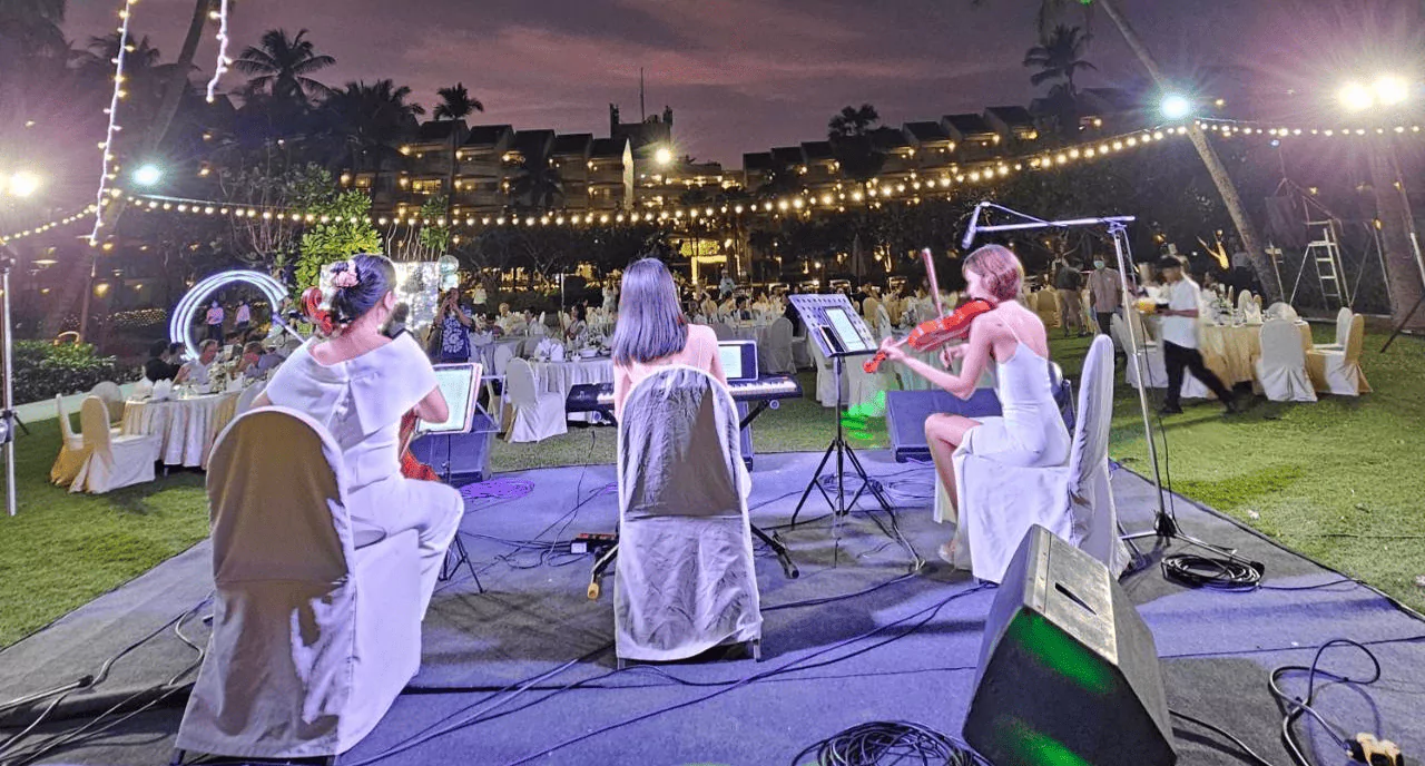 นักดนตรีสามคนกำลังเล่นดนตรีอยู่บนเวที